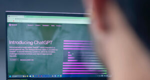 A person sitting and using a laptop with the ChatGPT screen open.